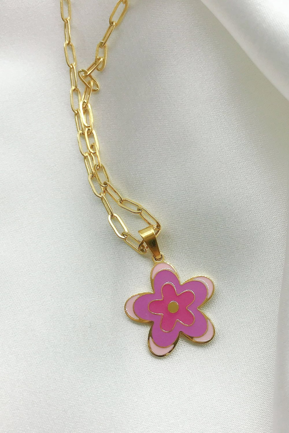 Gold-tone flower pendant necklace with purple enamel petals on chain