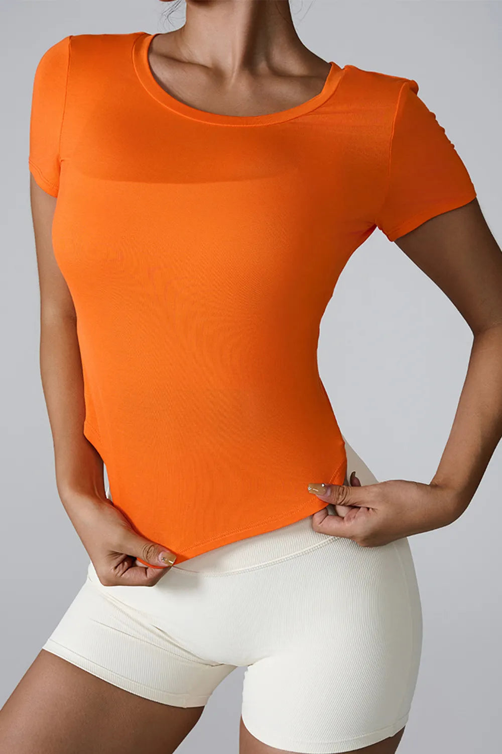 Orange active t-shirt with round neck and short sleeves, smooth fitted jersey