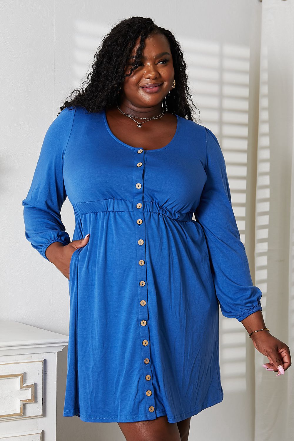 Royal blue scoop-neck long-sleeve dress with empire waist and button front