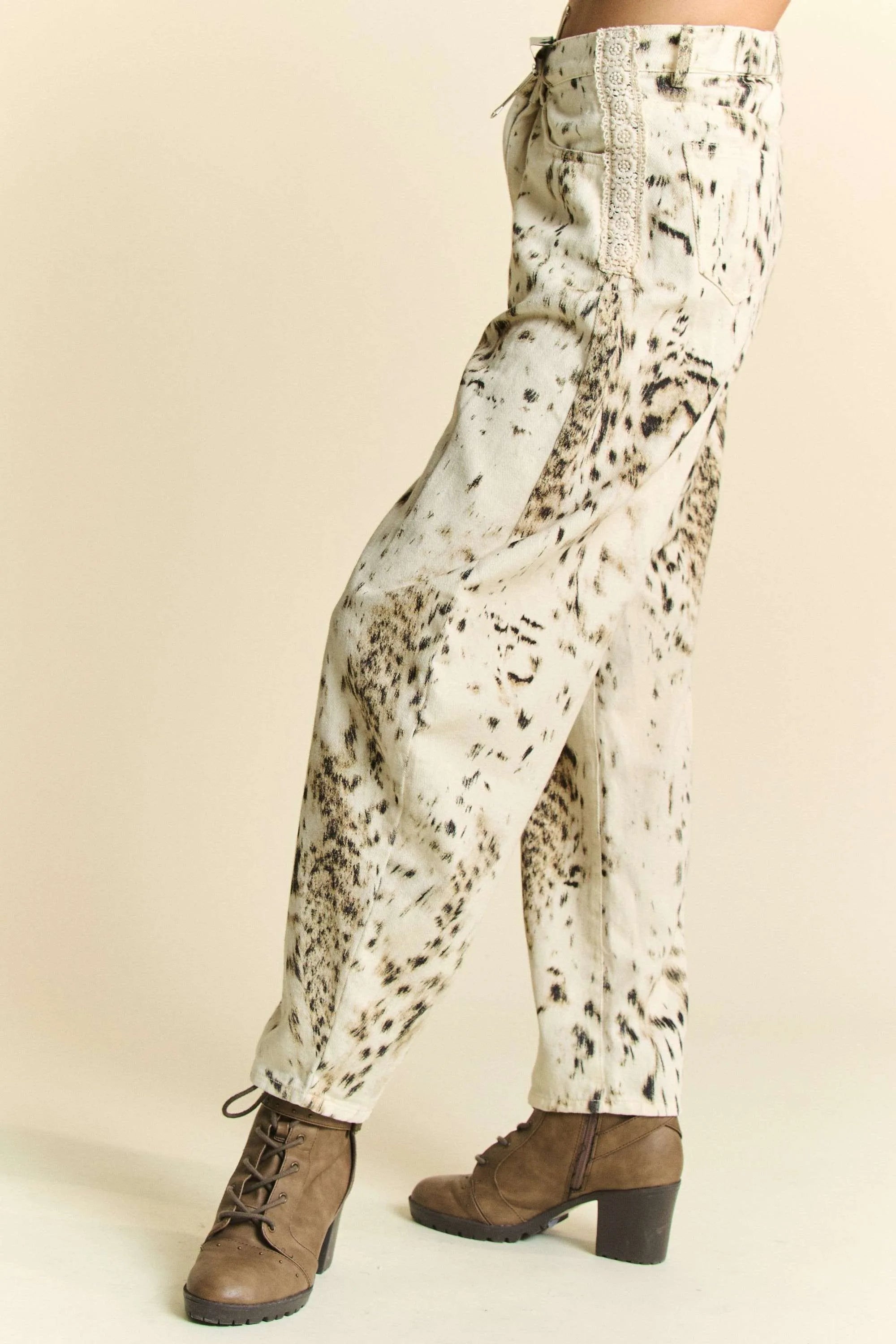 Cream barrel-leg pants with dense black speckle tie-dye dot pattern
