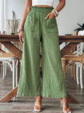 Green wide-leg pants with elastic waist and front patch pockets, textured drape