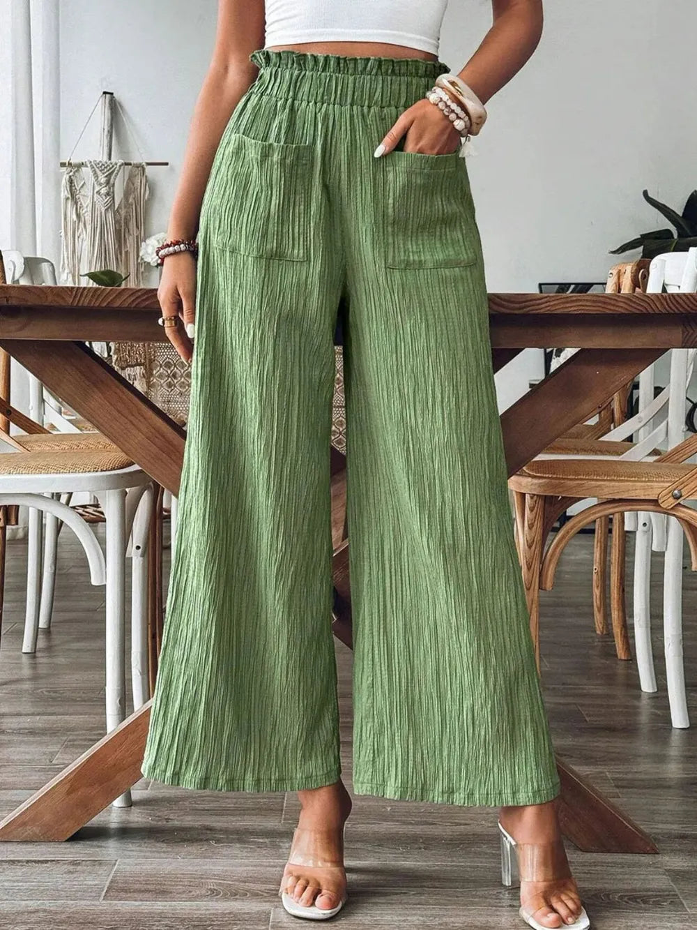 Green wide-leg pants with elastic waist and front patch pockets, textured drape
