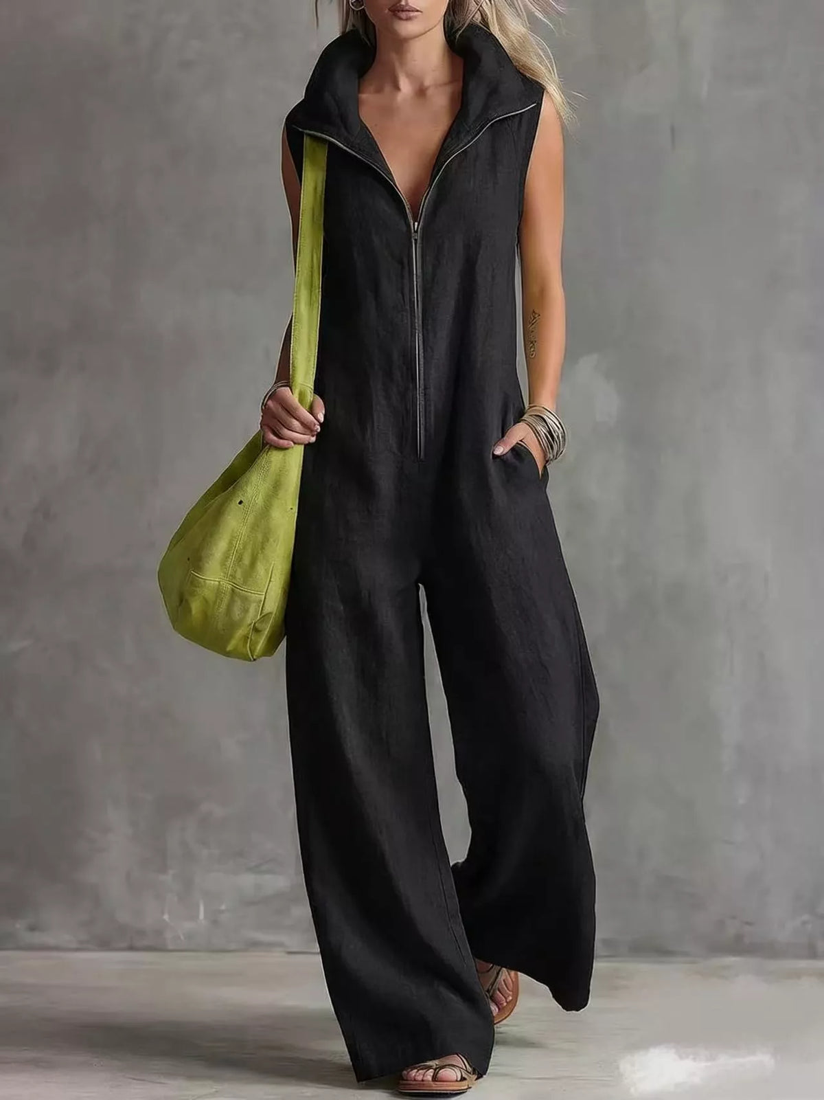 Black sleeveless zip-front jumpsuit with collar and front pockets, wide-leg silhouette