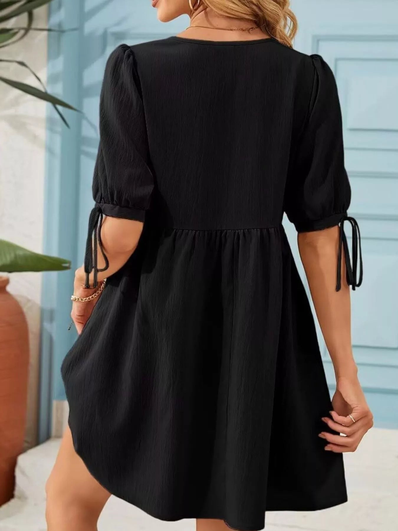 Trendsi black tie-neck puff-sleeve A-line mini dress, back view with cuff ties