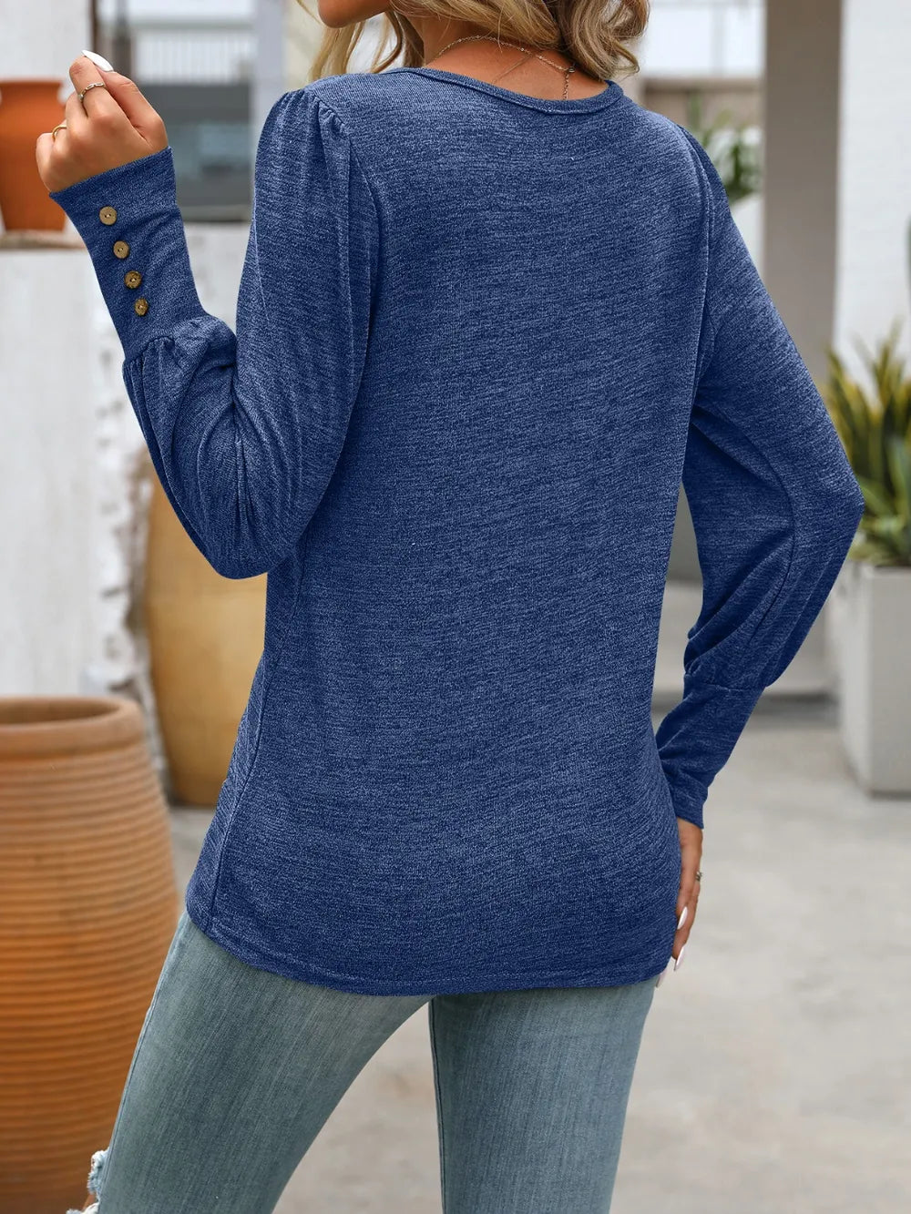 Navy long-sleeve t-shirt, crew neck with button detail at the cuffs.