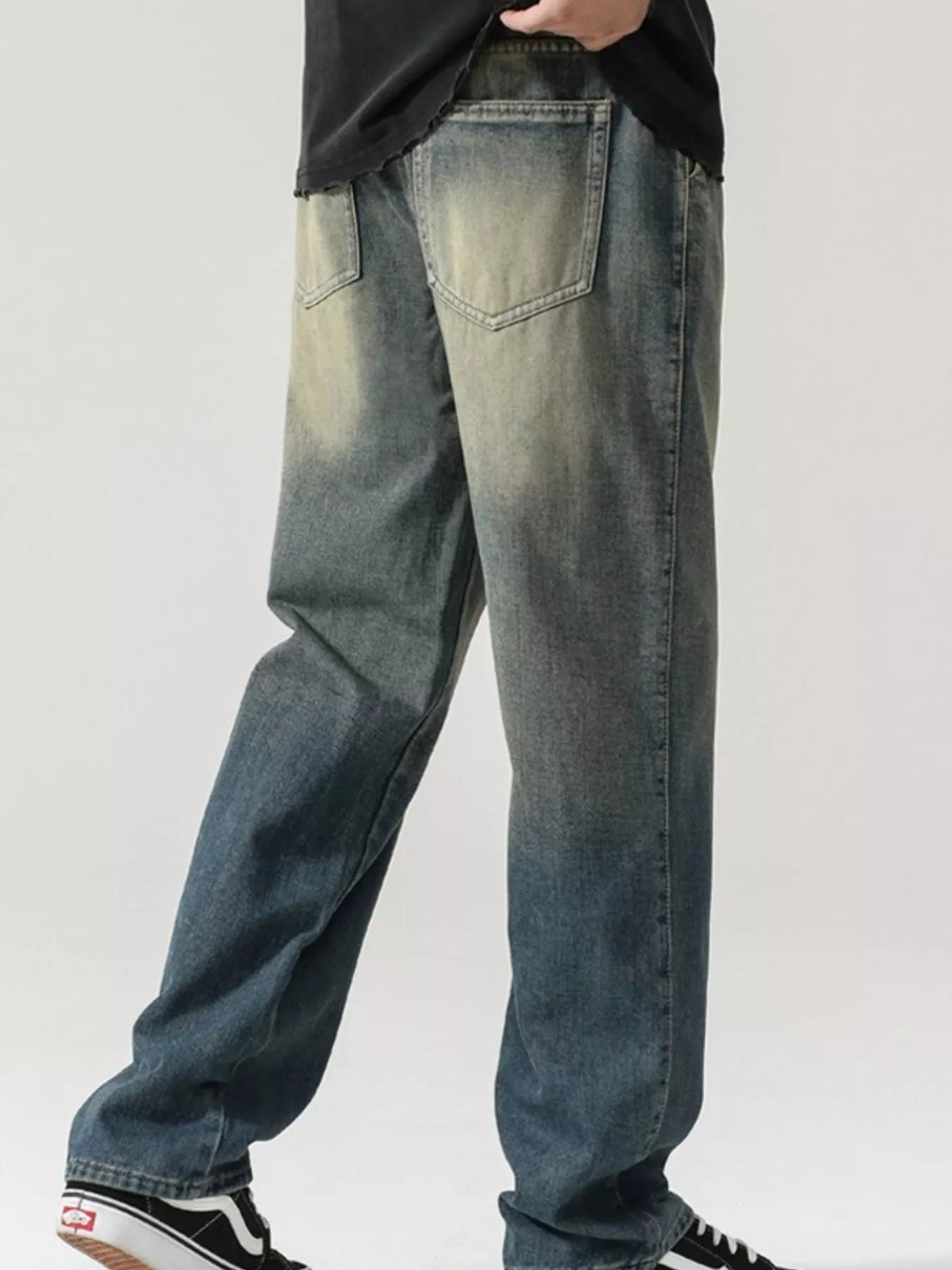 Men's washed teal denim jeans with stitched front pockets and relaxed wide-leg