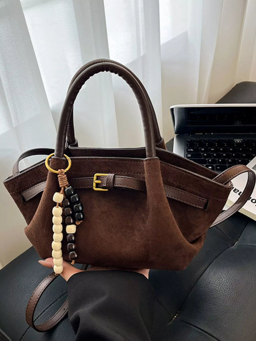 Brown suede tote bag with buckle strap detail and beaded tassel charm