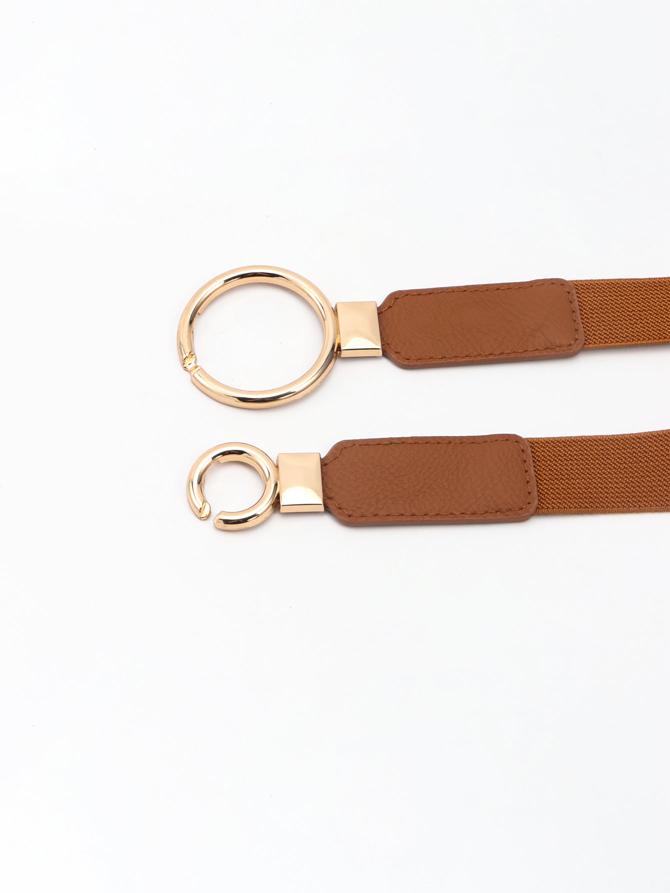 Brown elastic vegan leather belt close-up with double ring buckle and stitched panels