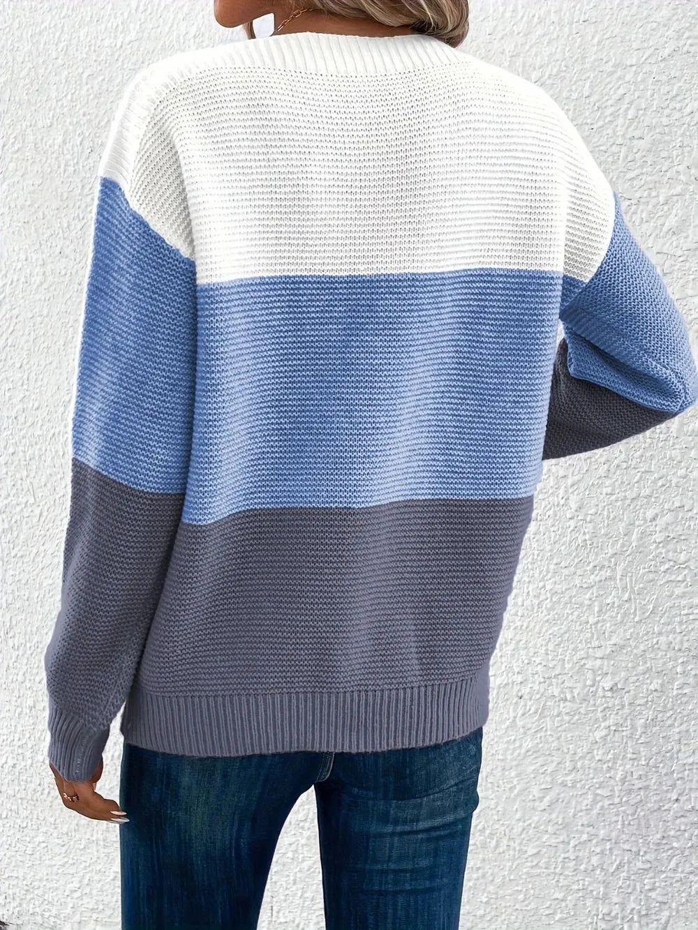 Back view of boat-neck color block sweater in white with light blue and dark gray bands