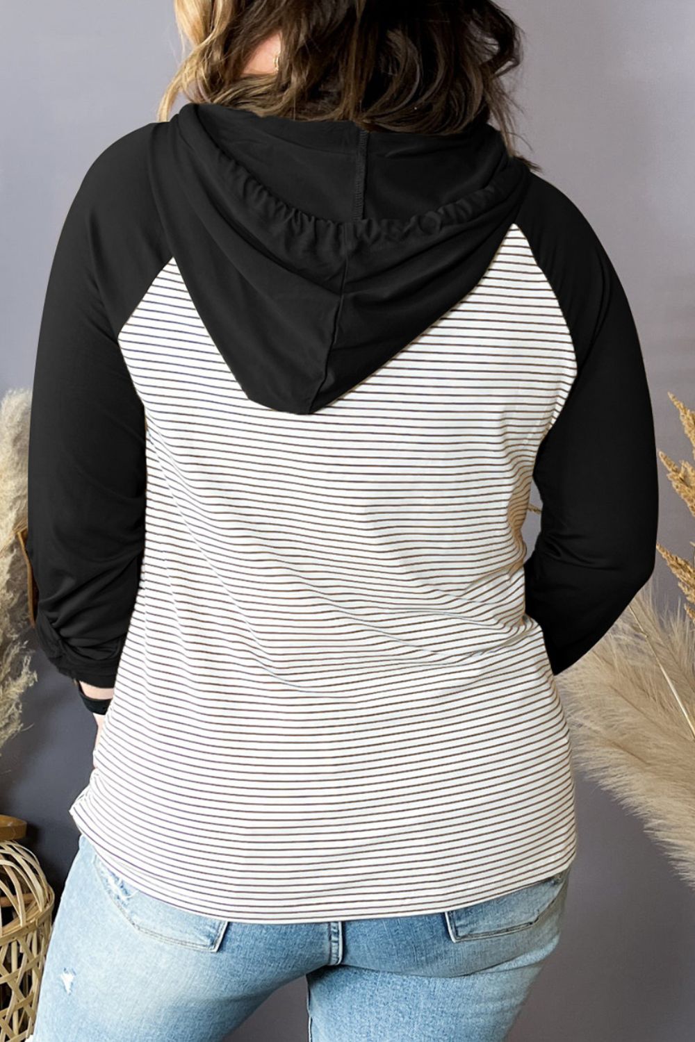 Plus-size striped long-sleeve hoodie back view, black hood, striped body, long sleeves.