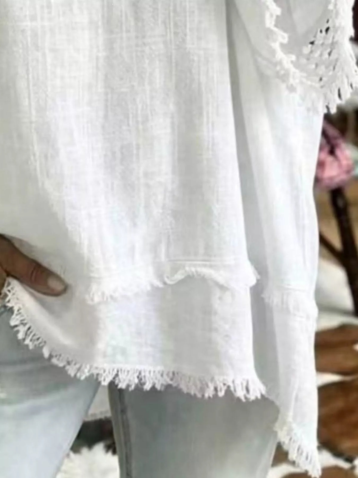 White blouse hem with fringe trim and airy loose fit