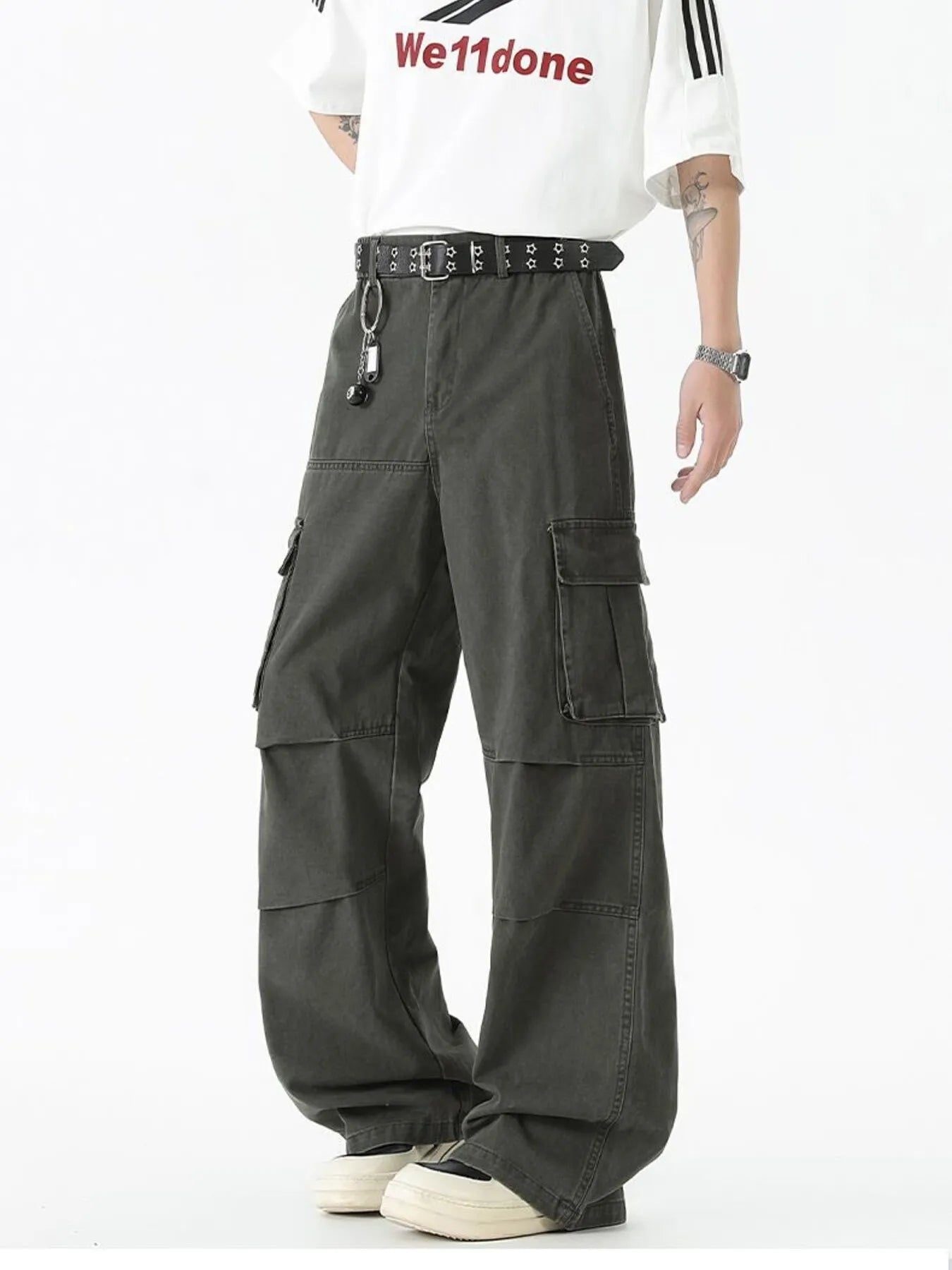 Dark green wide-leg cargo pants with front flap pockets, belt, and key ring
