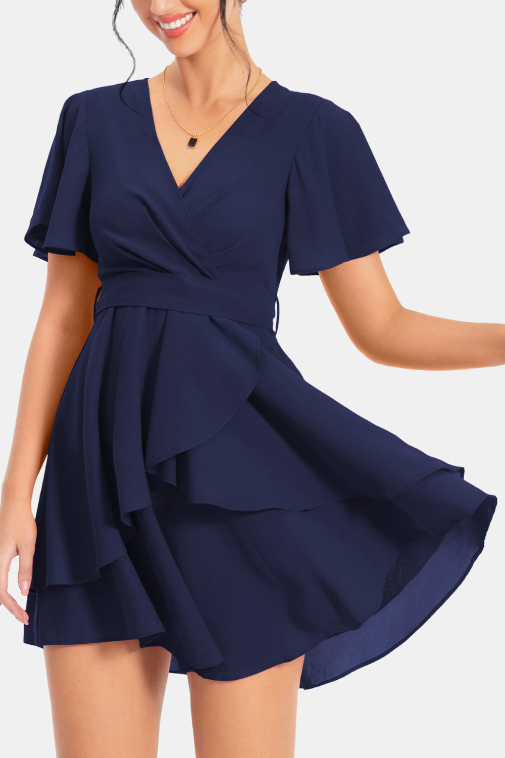 Navy surplice neck flutter sleeve dress with wrap bodice and tiered flared skirt