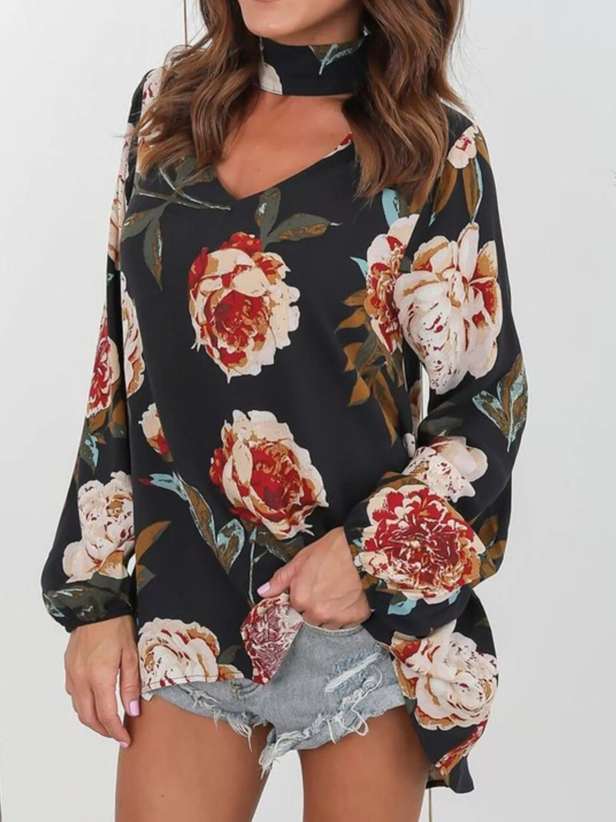 Black floral choker-neck long-sleeve blouse with large red and cream blooms