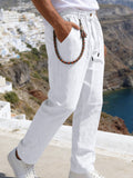 White drawstring pants with side pockets and elastic waistband