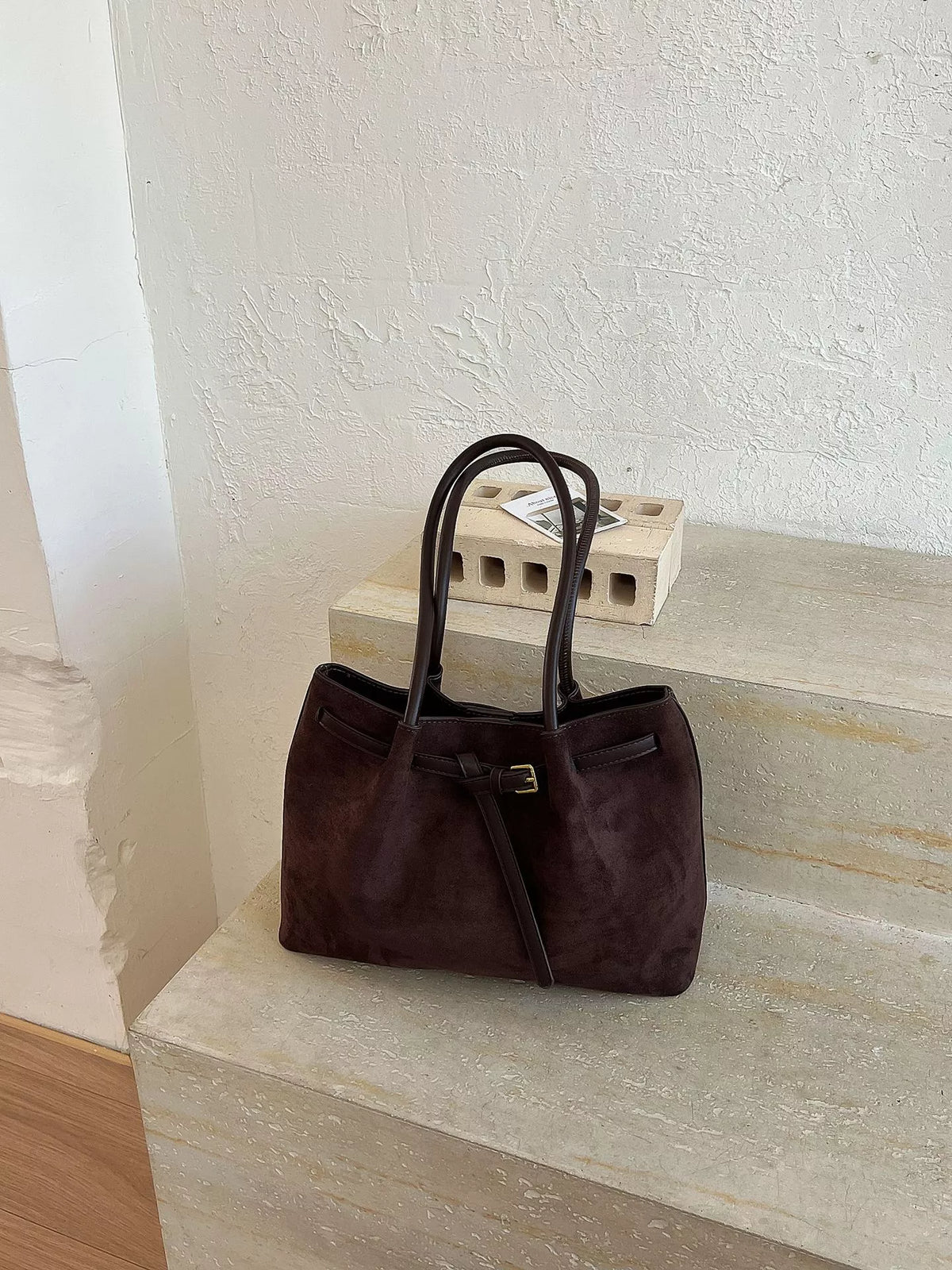 Dark brown suede shoulder tote bag with top handles and front pocket