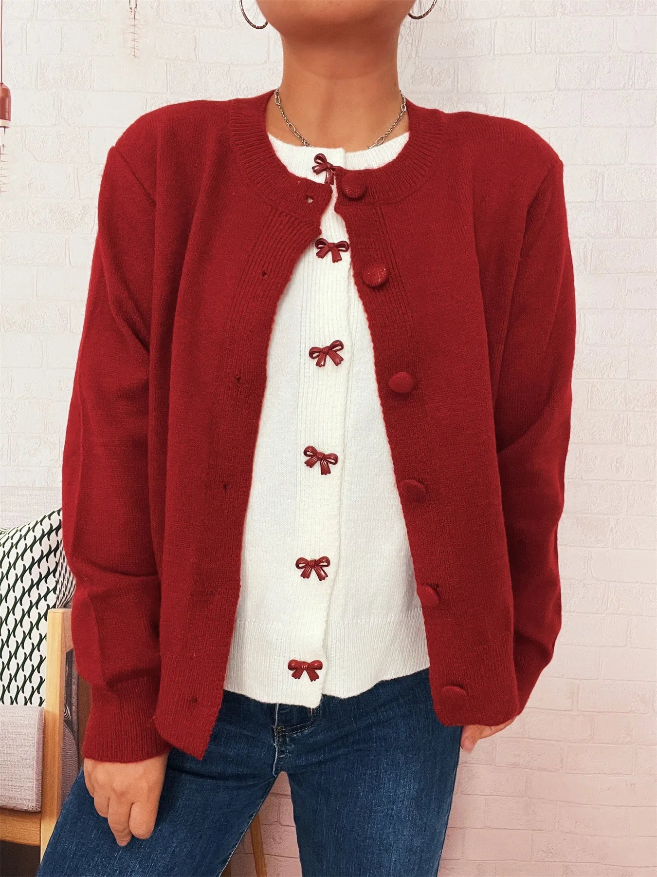 Red long-sleeve cardigan with button-front and small bow embroidery at chest