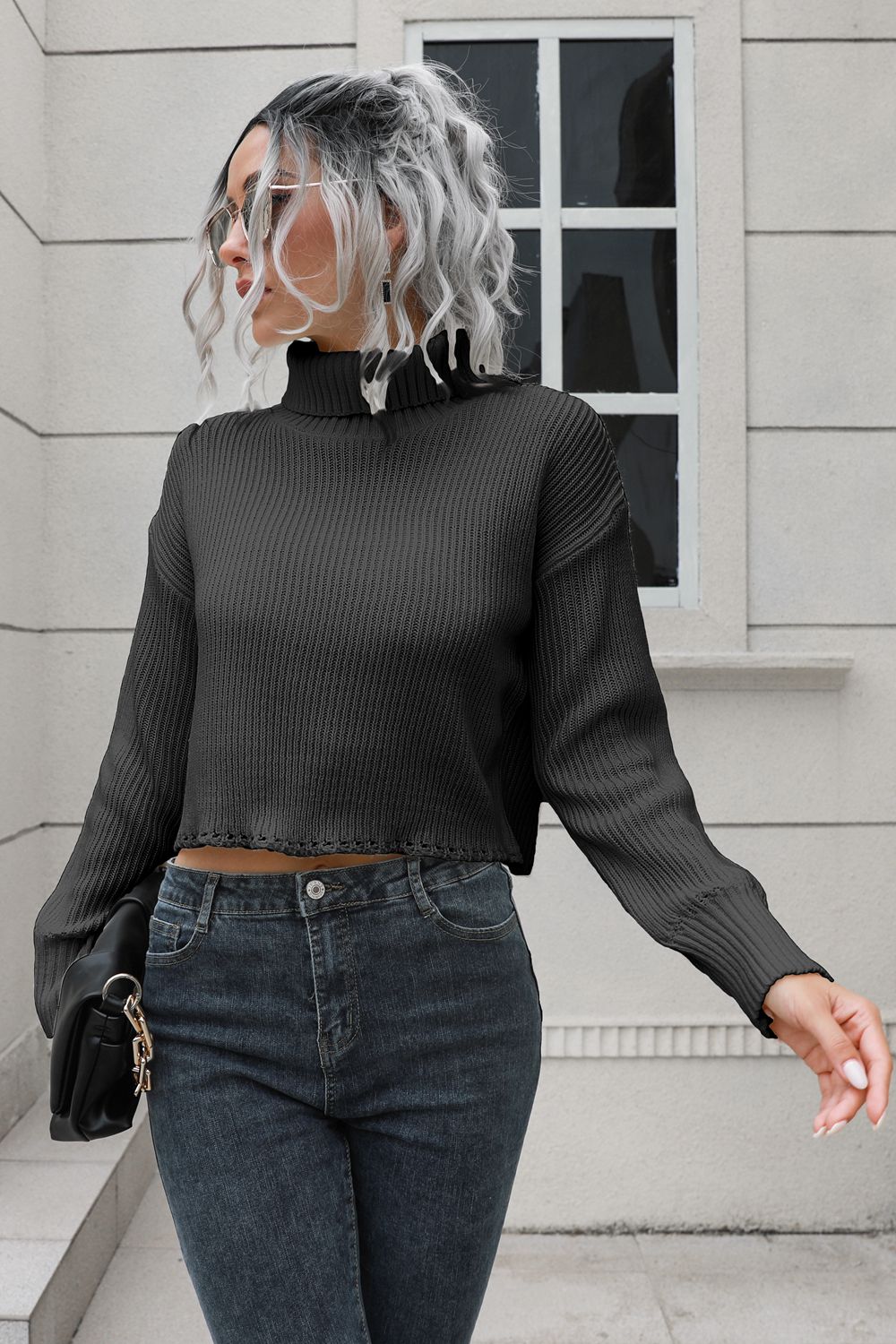Black turtleneck dropped-shoulder sweater, back view, ribbed knit, long sleeves.