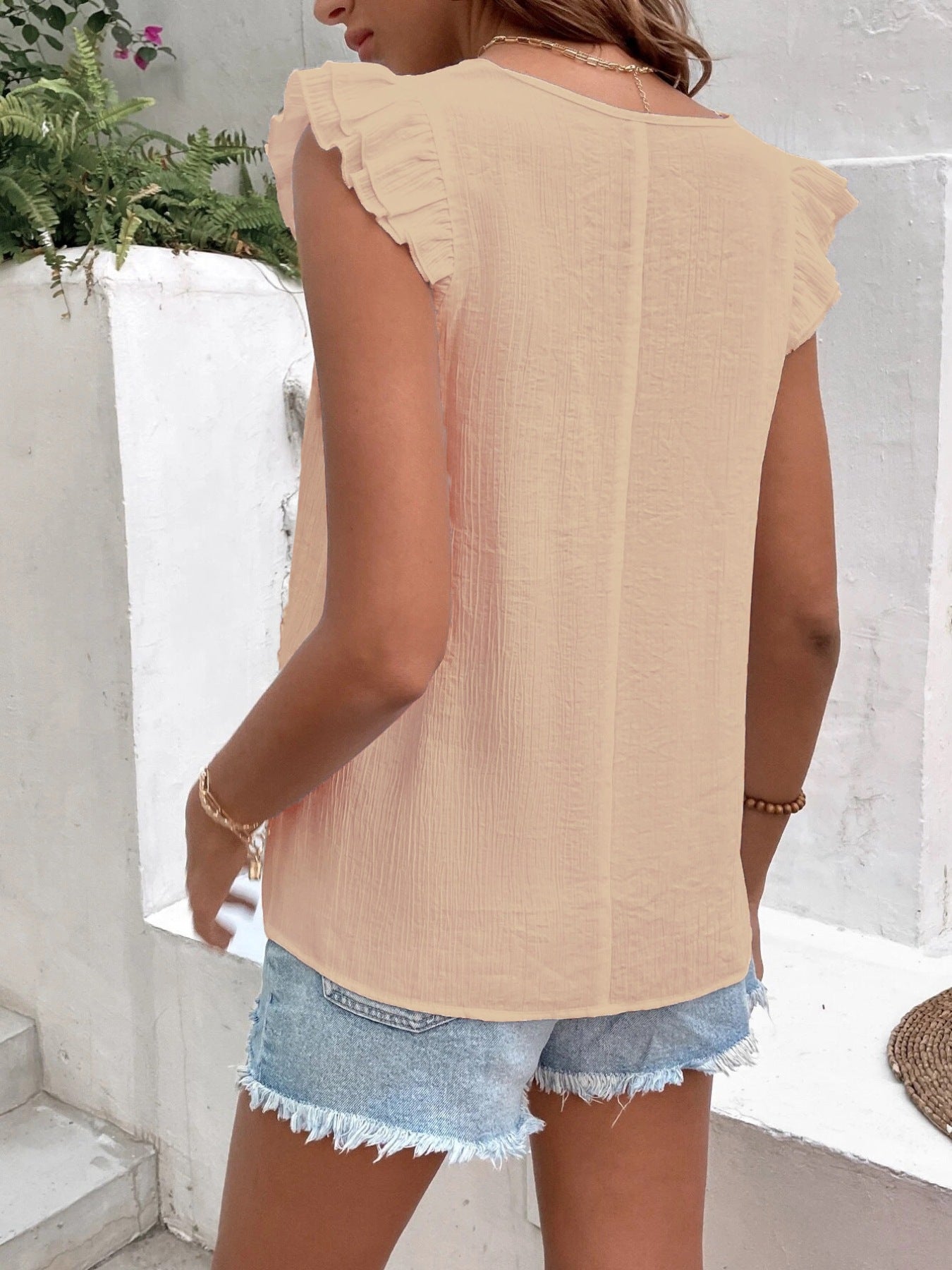 V-Neck Ruffled Cap Sleeve Blouse in peach textured fabric with delicate sleeve ruffles and a soft crinkled look