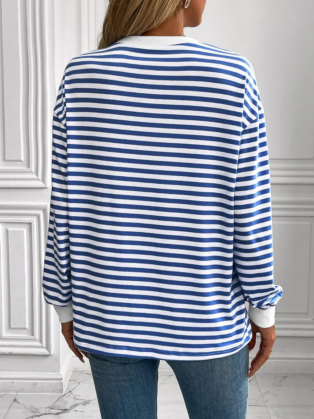 Striped crewneck long-sleeve sweatshirt in blue and white, back view