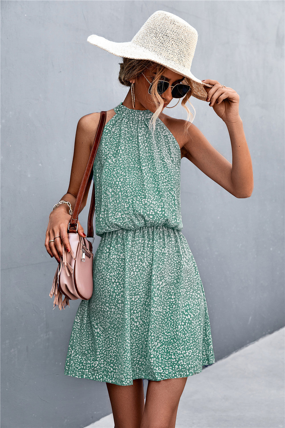 Floral tied sleeveless mini dress in green with halter neckline and tiered skirt