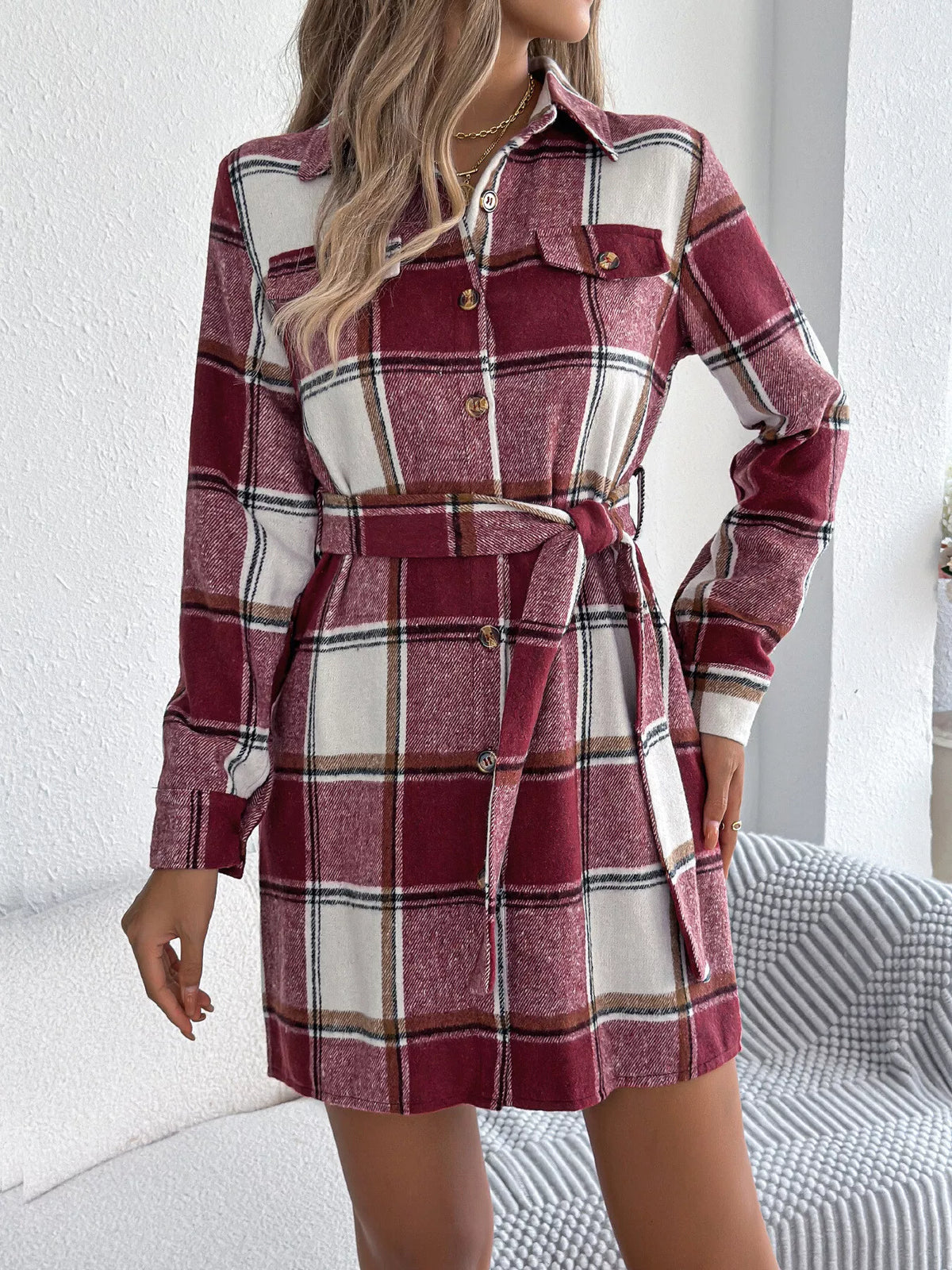 Burgundy plaid belted button shirt dress with collar, long sleeves, and chest pockets.