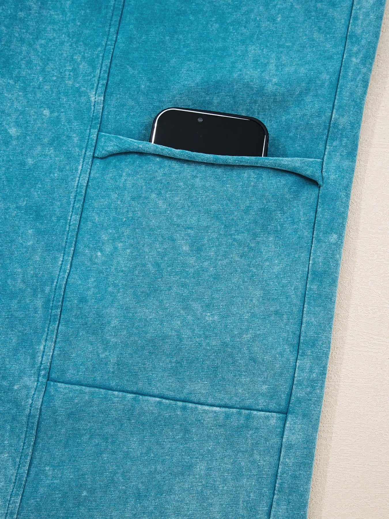 Teal patch pocket pants with large side pocket and topstitching detail