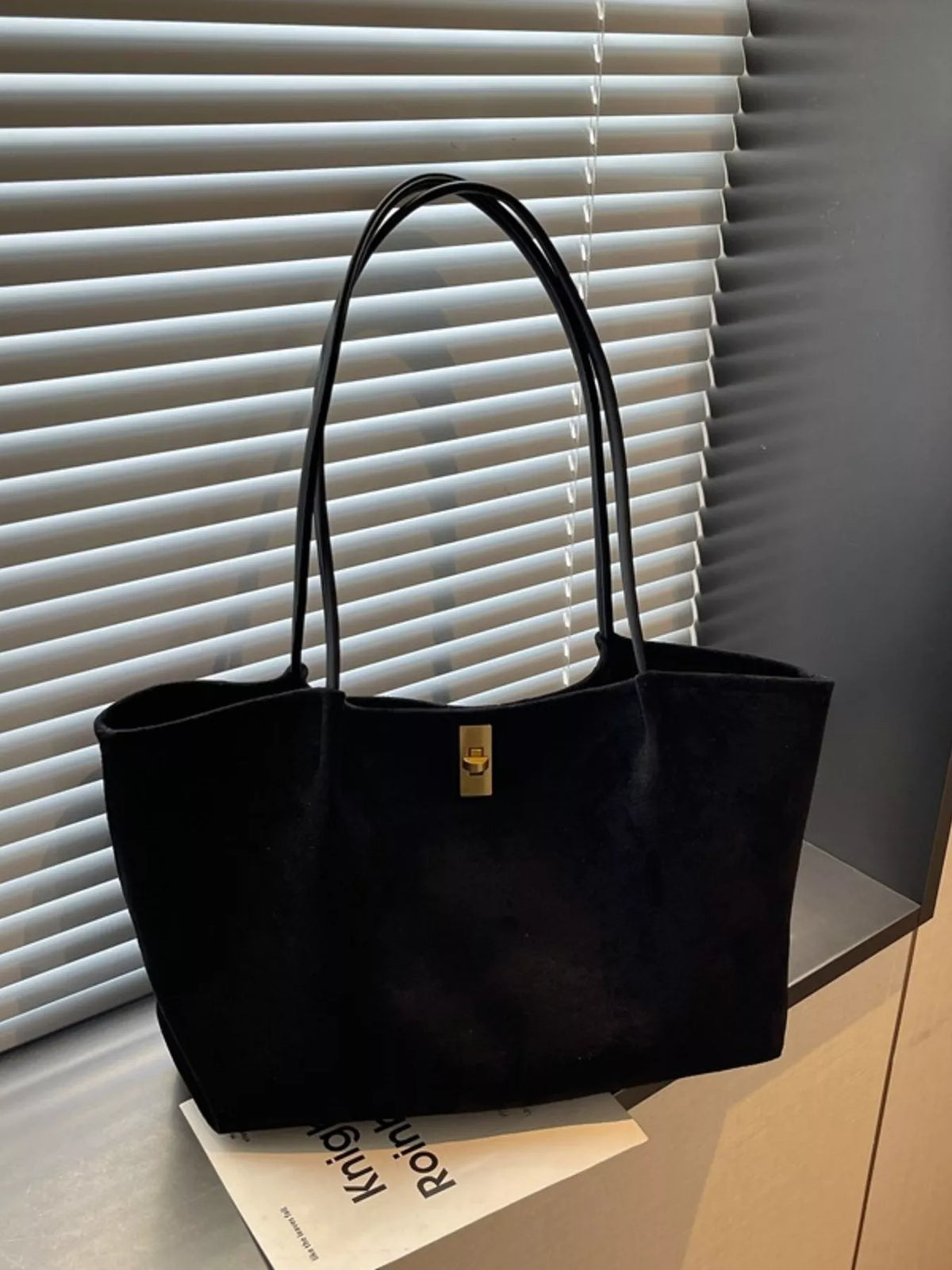 Black suede medium tote bag, front view, gold turn-lock clasp, top handles