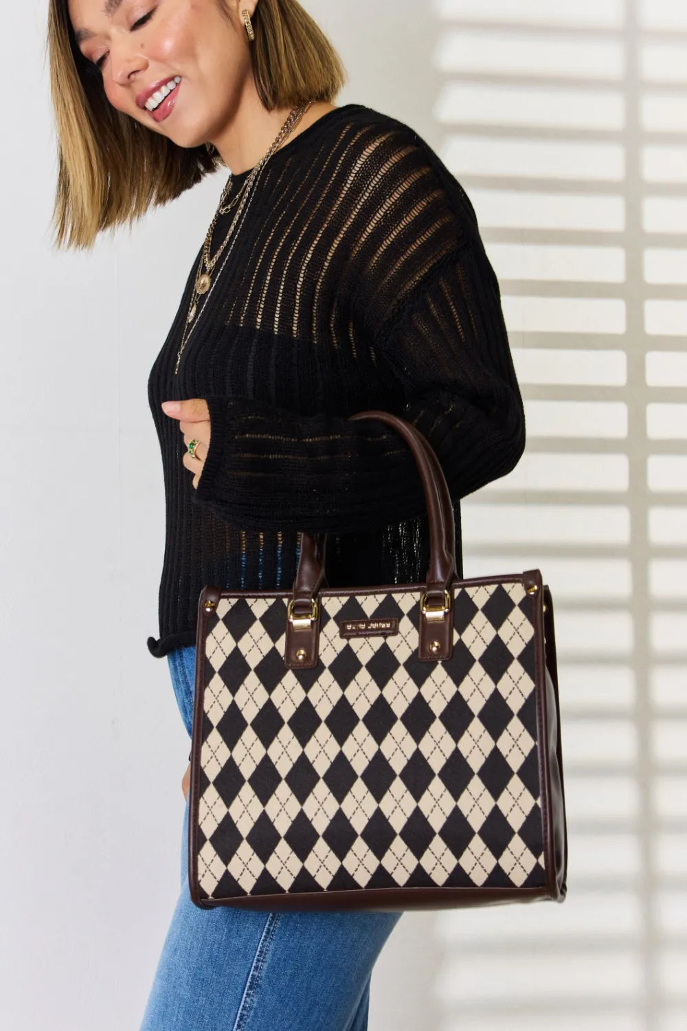 Argyle-pattern PU leather handbag with top handle, cream-and-black diamond print and studs