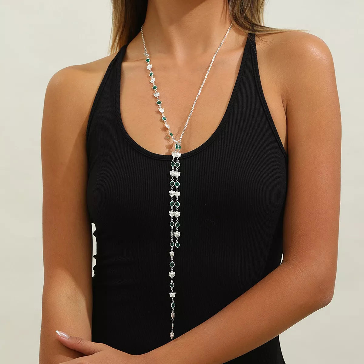 Silver rhinestone butterfly tassel drop necklace with teal bead accents