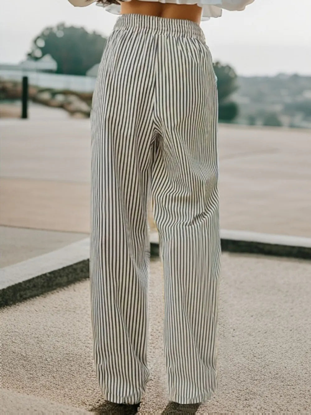 Striped elastic waist drawstring pants in black and white, standing full-body view