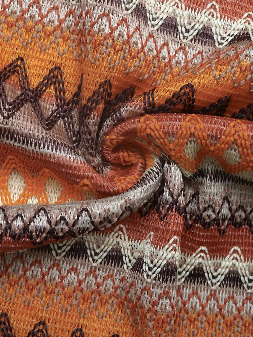 Woven striped dress fabric detail in caramel orange, cream, and dark brown