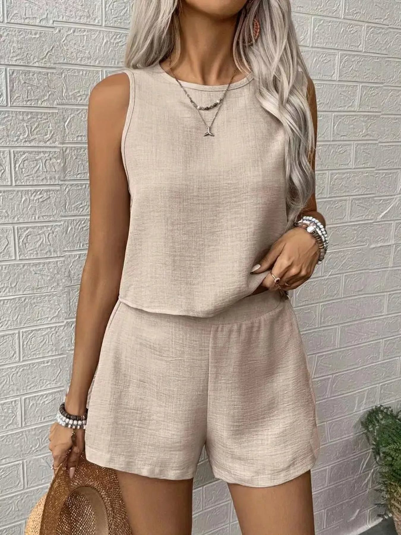 Beige round-neck sleeveless tank top and matching shorts set, relaxed layered look
