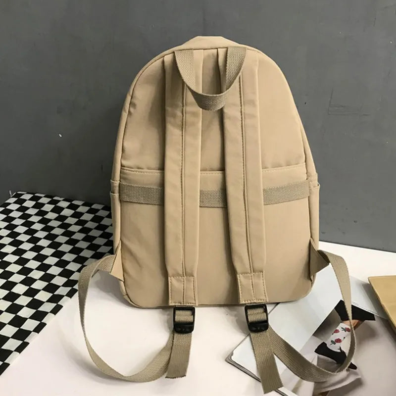 Khaki cotton zip backpack with padded back, twin shoulder straps, and front pocket