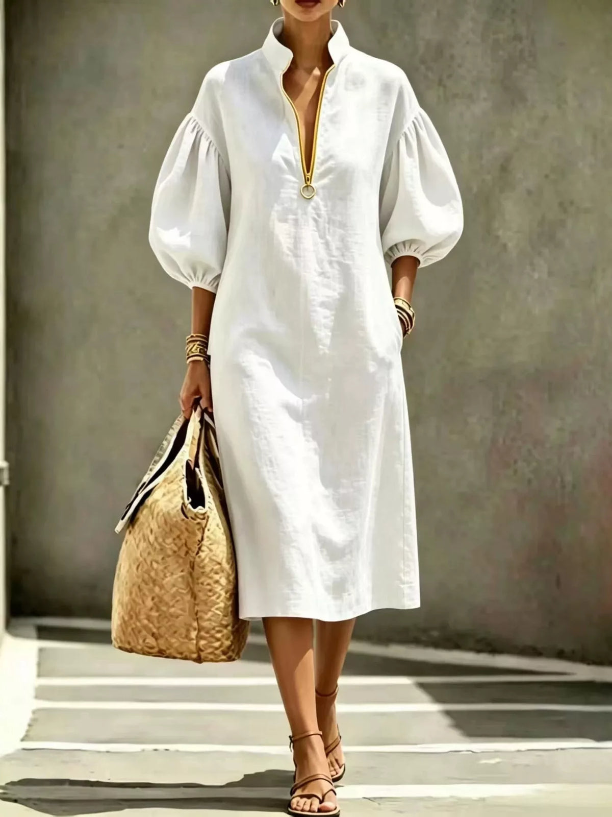 White midi dress with half-zip and puff sleeves, relaxed silhouette, gathered cuffs