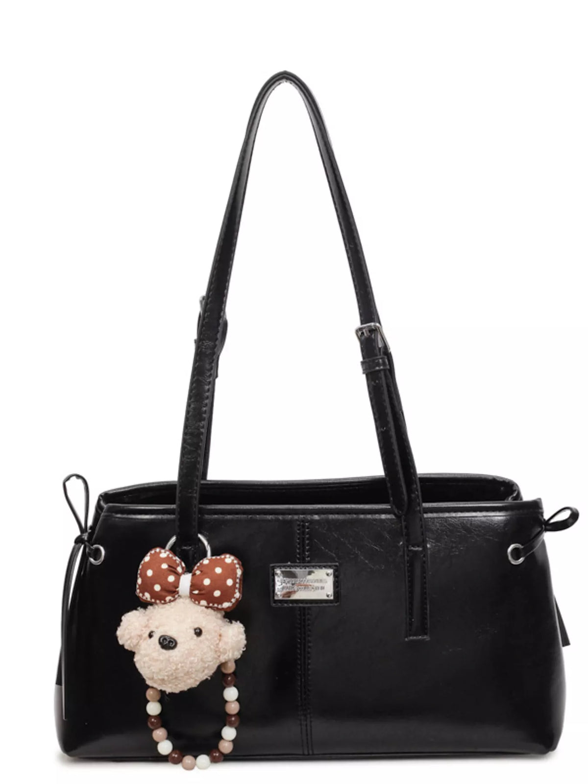 Black vegan leather medium shoulder bag with two handles, strap, and teddy front charm