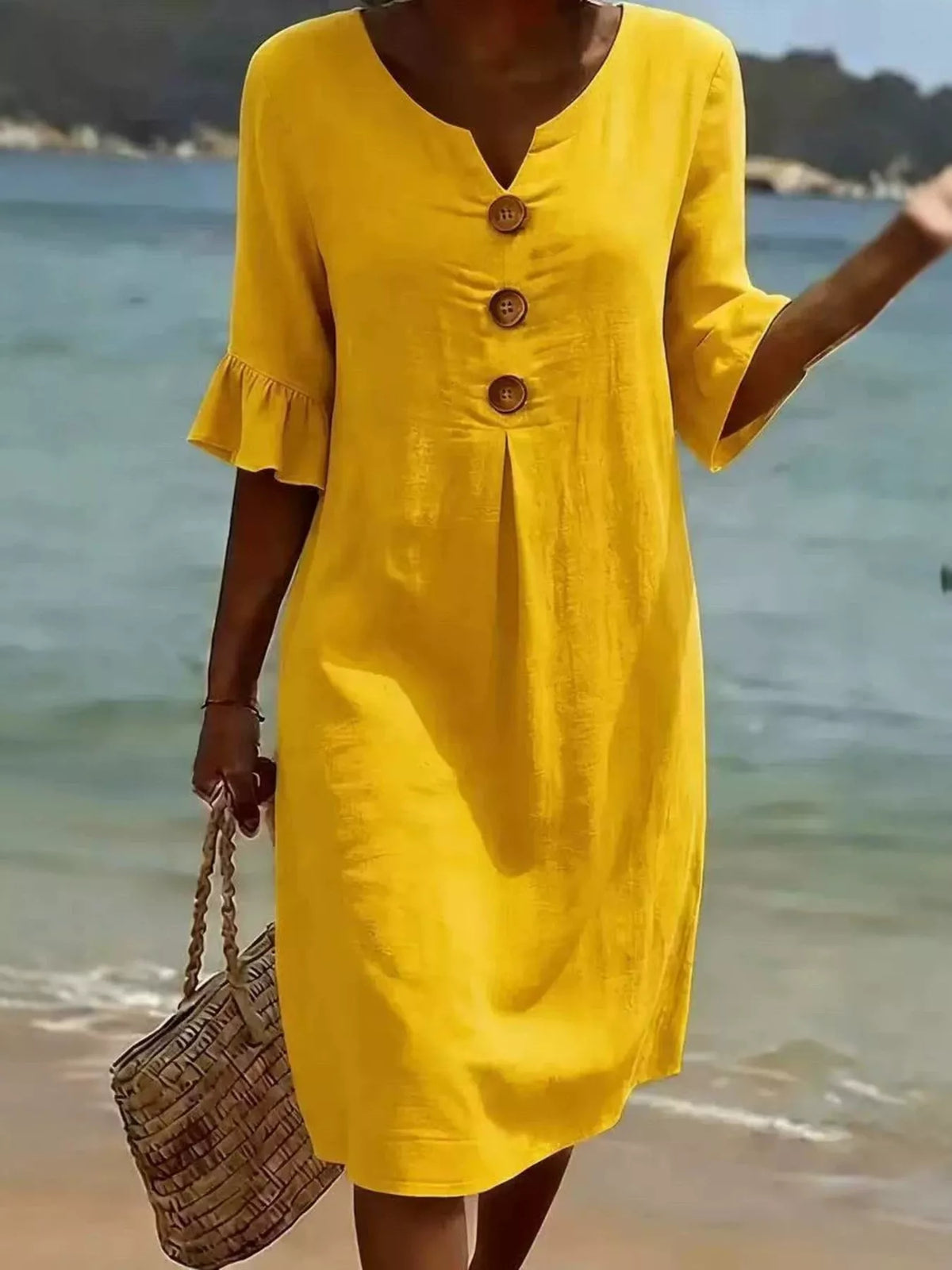 Yellow button-front dress with ruffle sleeves, V-neck, and three wood-look buttons