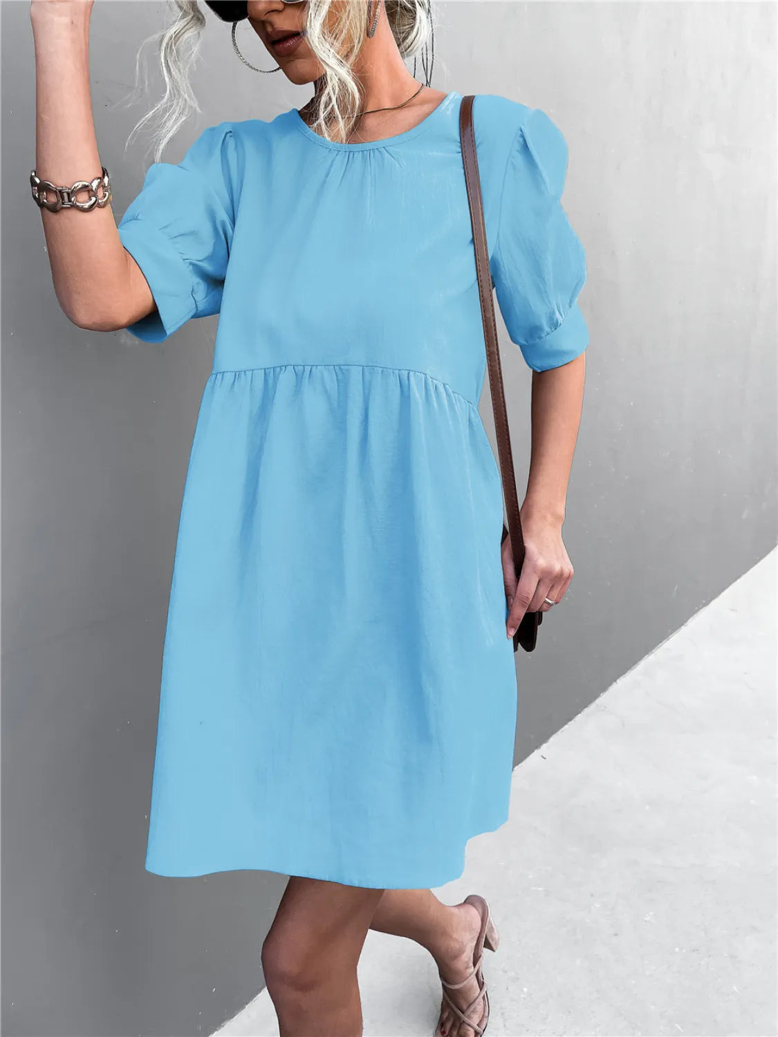 Round Neck Puff Sleeve Mini Dress in light blue by Trendsi, with gathered waist and brown crossbody bag