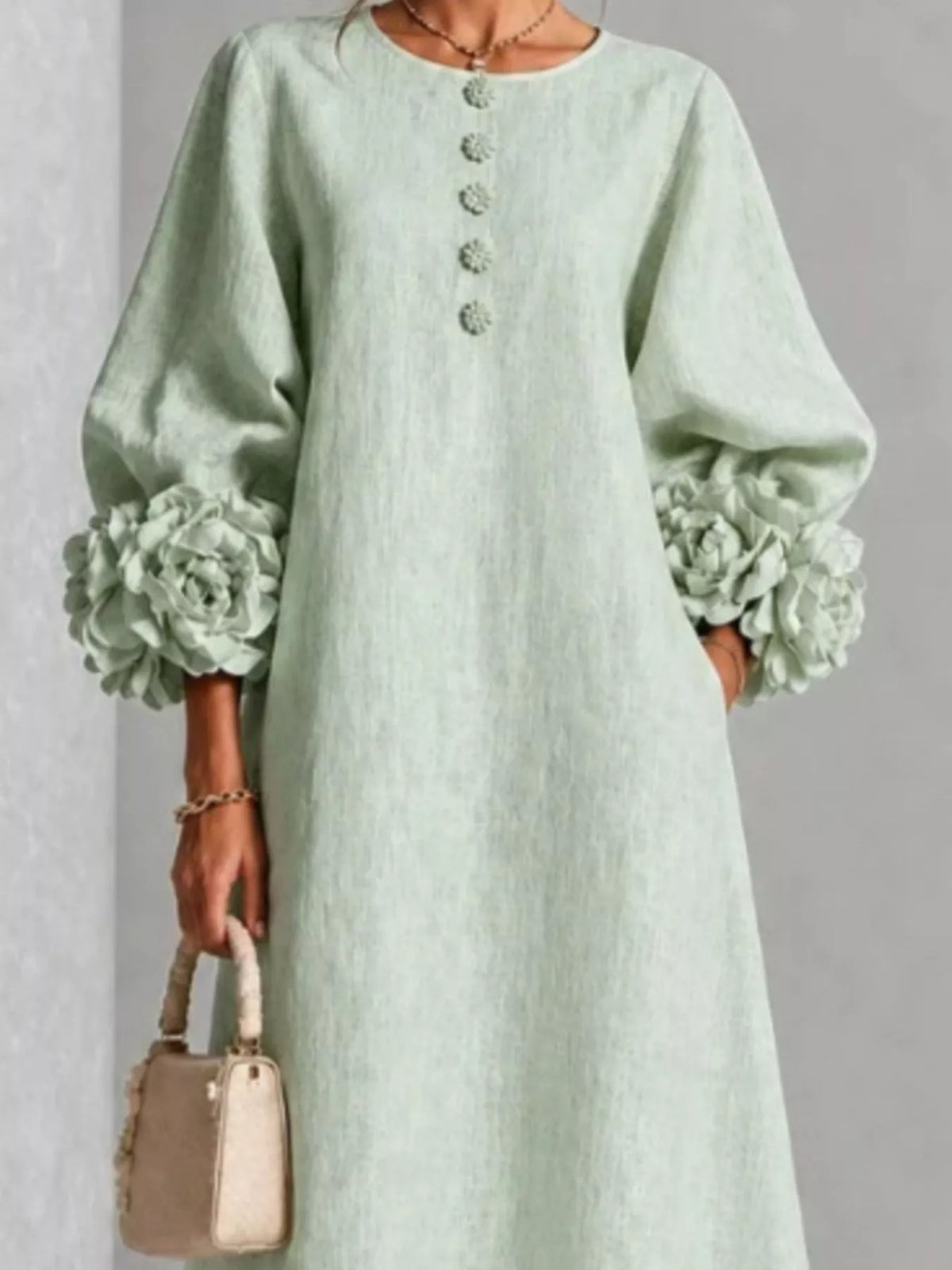 Sage green midi dress with round neck, button front, and 3D floral puff sleeve cuffs