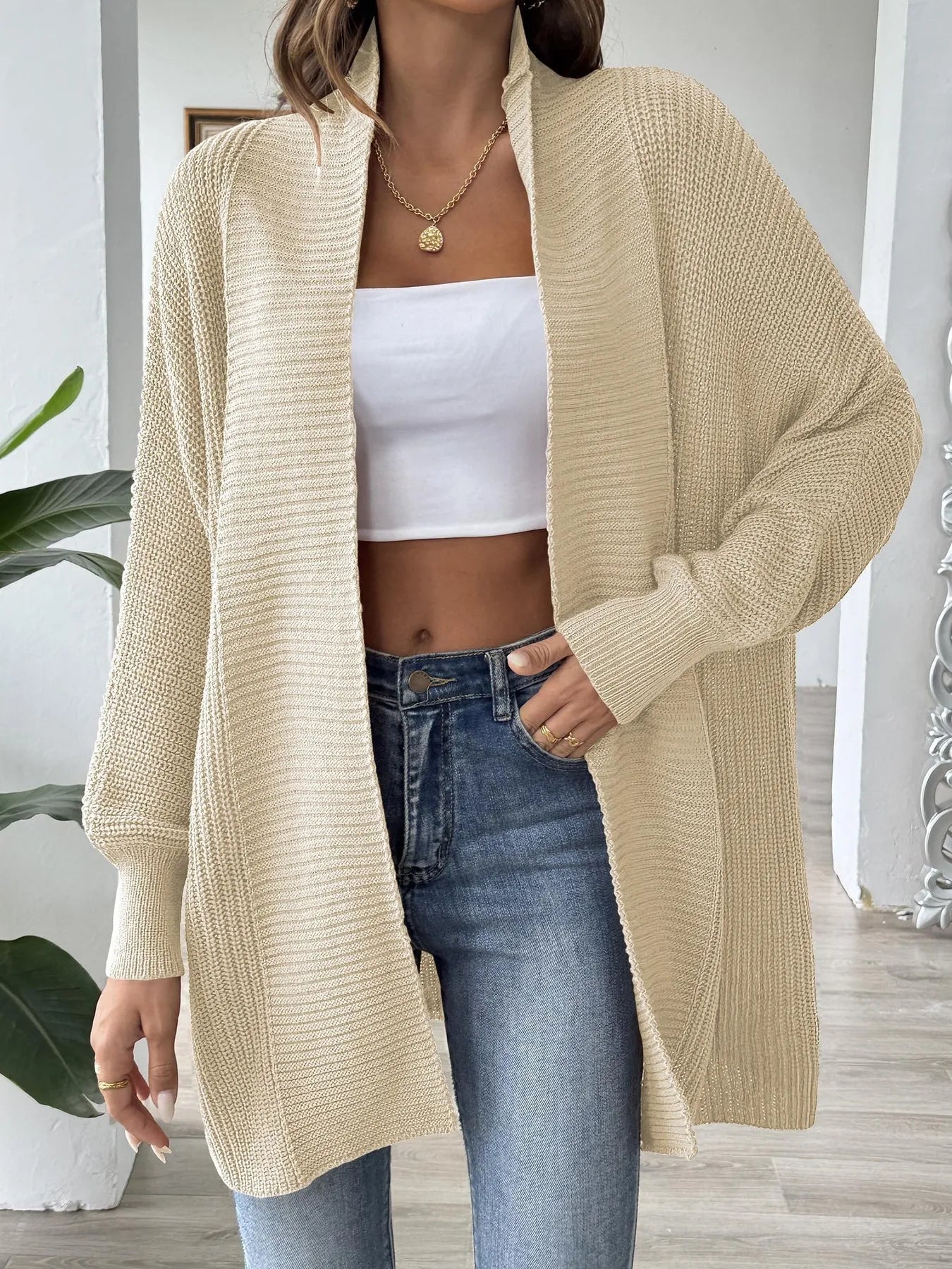Beige open-front knit cardigan, long sleeves, relaxed oversized fit, hip length