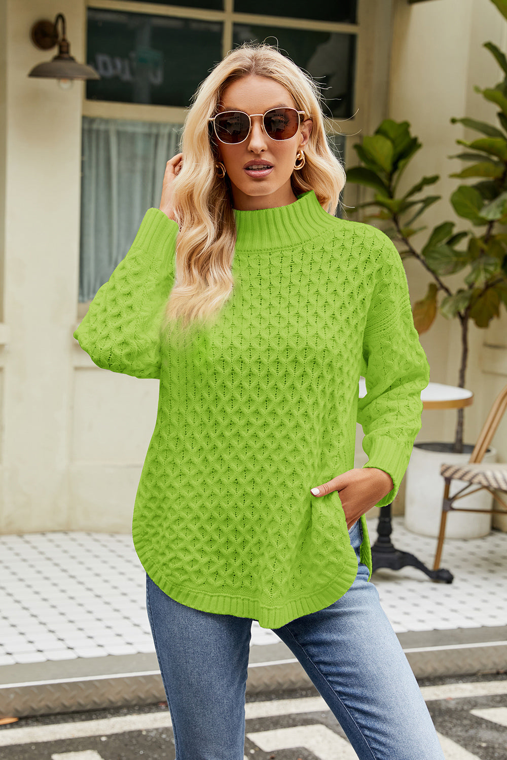 Neon green slit long-sleeve mock neck sweater with textured diamond knit pattern