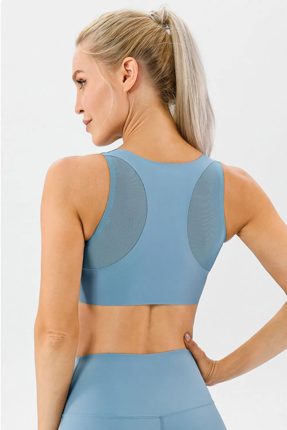 Light blue active bra with wide back straps and racer back, back view