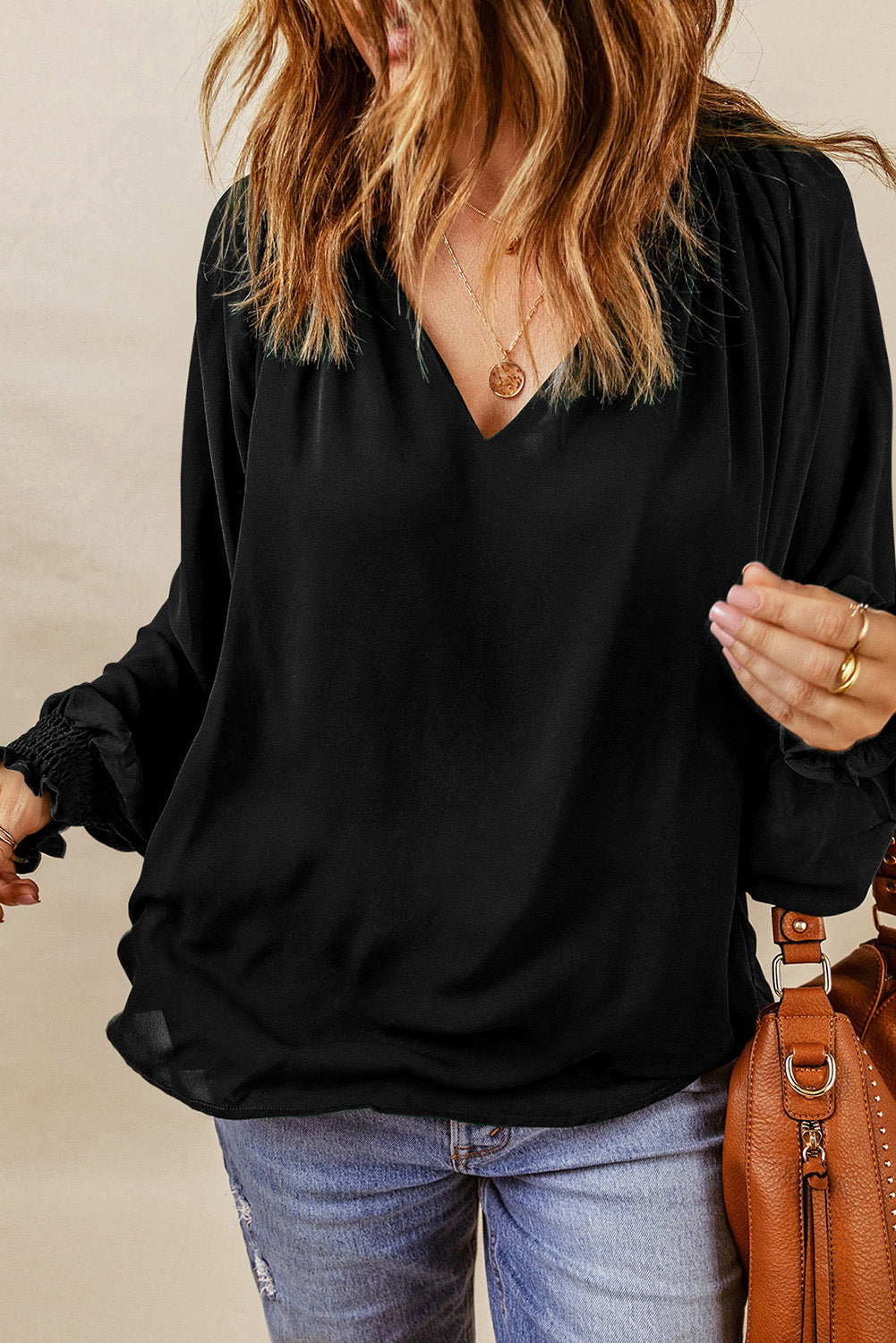 Black lantern sleeve blouse with notched V-neck and gathered cuffs at hem sleeves