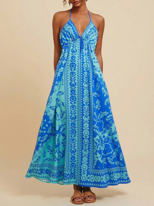 Blue halter maxi dress with V-neck and bohemian floral print, sleeveless, tiered hem