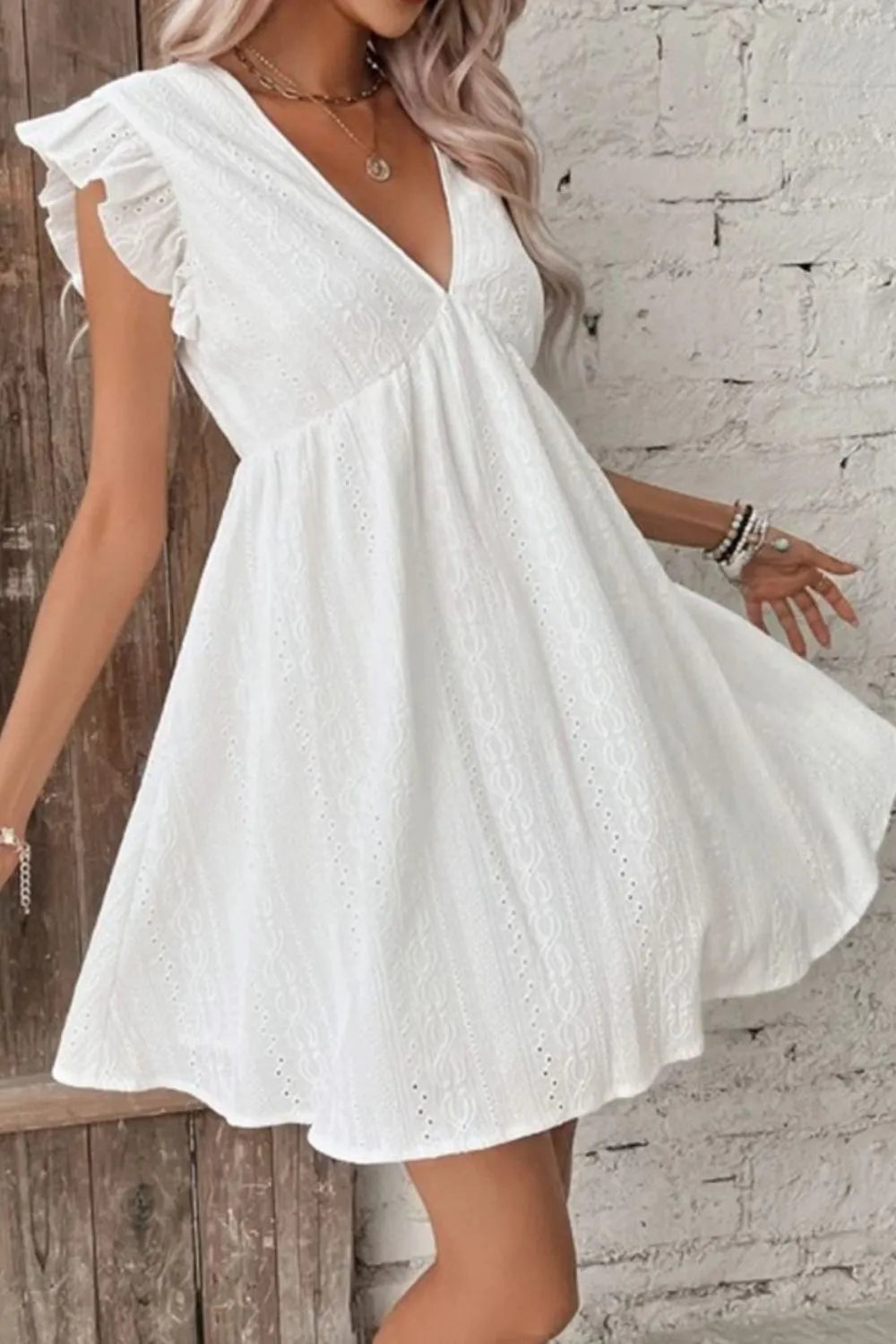 White eyelet V-neck mini dress with ruffled cap sleeves and gathered waist