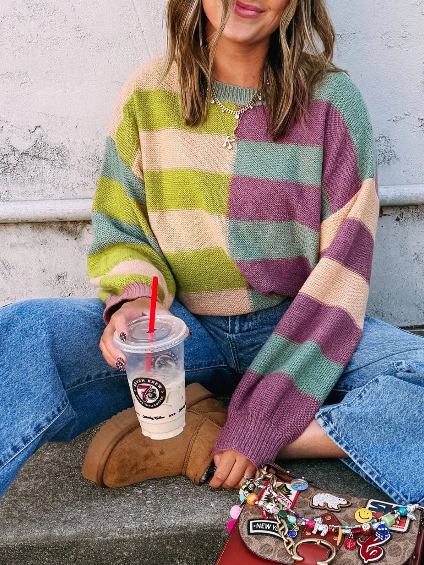 Multicolor striped sweater with ribbed hem and cuffs in green, purple, and cream