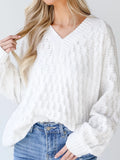 White textured knit V-neck loose sweater with ribbed cuffs and neckline.