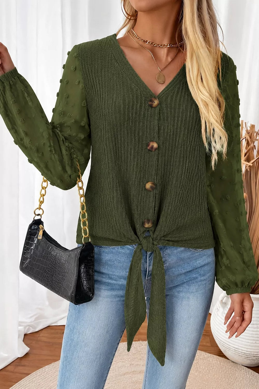 Dark green swiss-dot long-sleeve blouse with V-neck buttons and front tie hem