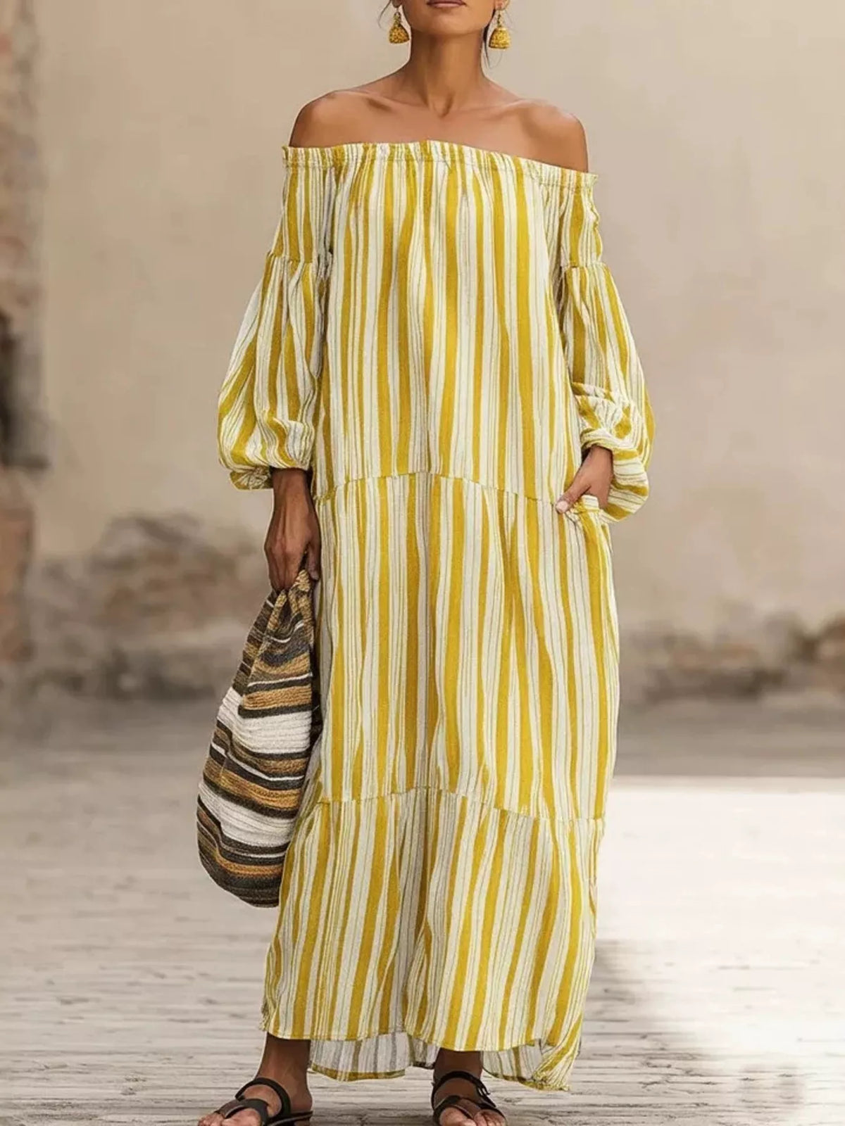 Off-shoulder striped maxi dress in pastel yellow with white vertical stripes, tiered skirt