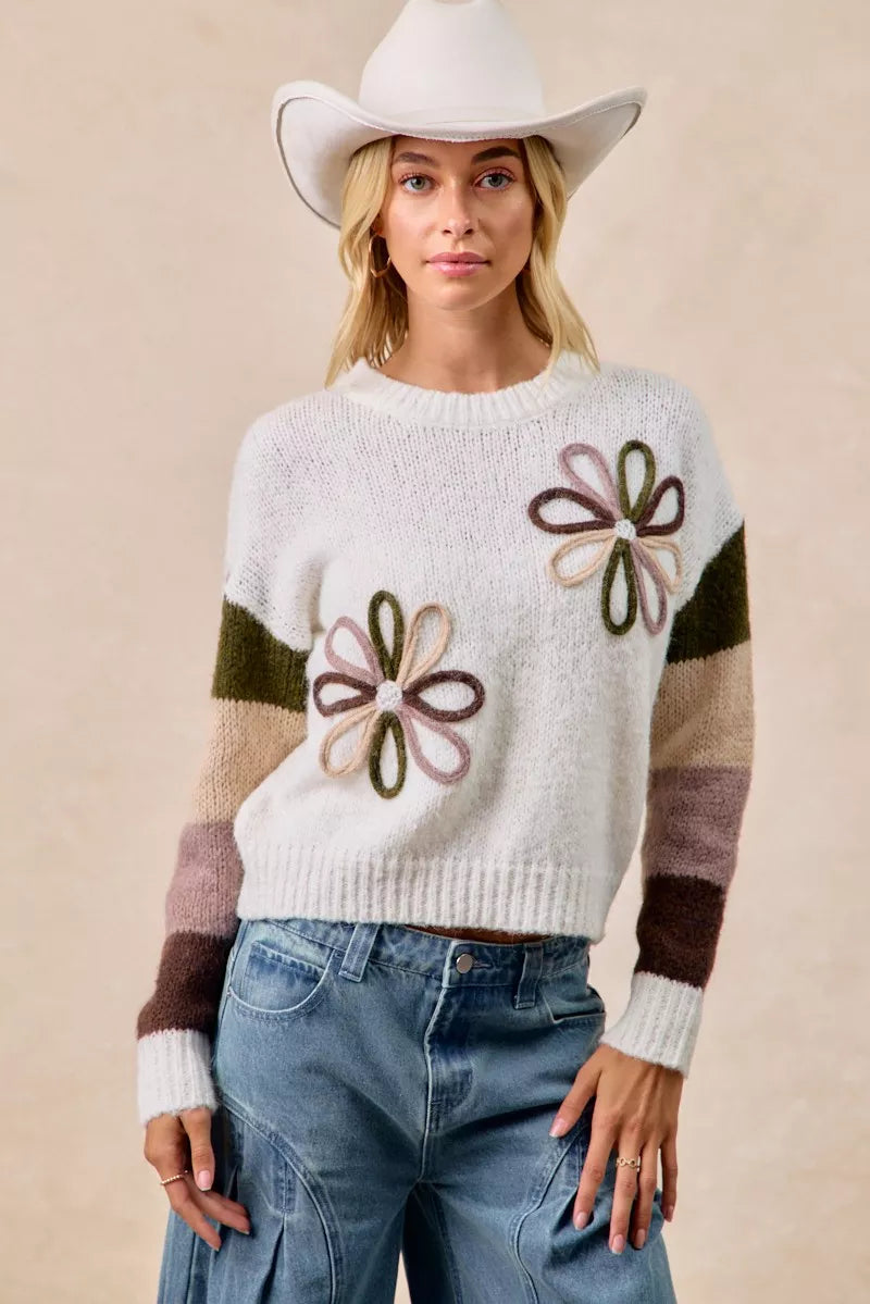 Ivory color-block sweater with flower appliques and striped sleeves, crewneck knit